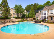 Thumbnail 2 of 25 - Pet-Friendly Apartments in Alpharetta, GA – The Ascent at Windward – Resort style pool with seating around the sundeck