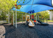 Thumbnail 23 of 33 - Pet-Friendly Apartments in Coconut Creek, FL – Waterview at Coconut Creek – playground with a slide and other playground equipment