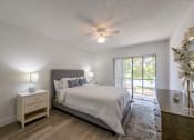 Thumbnail 9 of 33 - Pet-Friendly Apartments in Coconut Creek, FL – Waterview at Coconut Creek – white bedroom with a bed and a ceiling fan