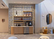 Thumbnail 32 of 67 - the lobby of a hotel with a coffee machine and a counter