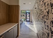 Thumbnail 53 of 67 - a hallway with a white wallpaper with people on it