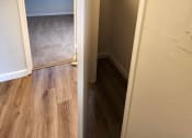 Thumbnail 6 of 8 - an empty hallway with a door open to a closet and a window