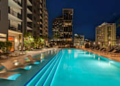 Thumbnail 3 of 18 - A long rectangular pool with lounge chairs on the side.