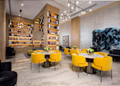 Thumbnail 16 of 18 - A modern dining room with a large table surrounded by yellow chairs.