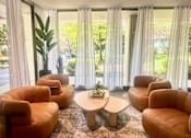 Thumbnail 9 of 36 - A room with orange chairs and a table with a plant on it. at Calvert House Apartments, Washington, DC 20008