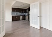 Thumbnail 6 of 15 - A kitchen with dark brown cabinets and a white door.