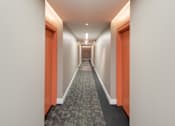 Thumbnail 13 of 15 - A long hallway with orange doors and a carpeted floor.