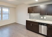 Thumbnail 4 of 15 - A kitchen with brown cabinets and a white sink.