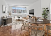 Thumbnail 1 of 59 - A modern living room with a wooden floor and furniture.