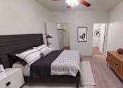 Thumbnail 4 of 63 - A bedroom with a bed, nightstand, and a wooden cabinet.