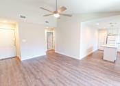 Thumbnail 1 of 27 - A room with a ceiling fan and wooden flooring.