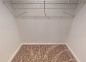Thumbnail 15 of 27 - A room with a carpeted floor and a ceiling fan.