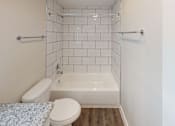 Thumbnail 41 of 42 - A white toilet and sink in a small bathroom.
