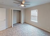 Thumbnail 13 of 42 - A room with a ceiling fan and a window with blinds.