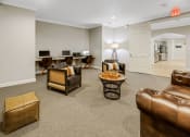 Thumbnail 16 of 26 - a living room with couches and chairs and a desk