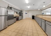 Thumbnail 26 of 26 - a large kitchen with stainless steel appliances and tile flooring