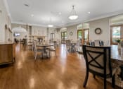 Thumbnail 20 of 26 - a large dining room with tables and chairs and a fireplace