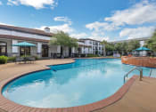 Thumbnail 6 of 26 - a large swimming pool with a hotel in the background