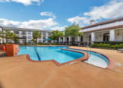 Thumbnail 3 of 26 - a swimming pool with a building in the background