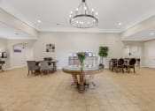 Thumbnail 12 of 26 - a dining room with a table and chairs and a chandelier