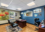 Thumbnail 21 of 24 - a business office with blue walls and a wood floor