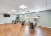 Thumbnail 15 of 24 - a conference room with tables and chairs and a wall mounted tv