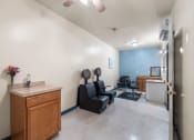 Thumbnail 9 of 24 - a dentist office with a chair and a counter and a exam room
