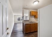 Thumbnail 2 of 24 - an empty kitchen with wooden cabinets and a sink