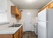 Thumbnail 1 of 24 - a kitchen with white appliances and wooden cabinets