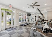 Thumbnail 18 of 26 - A Spinning bike is in a well lit gym with a checkerboard floor.