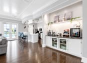 Thumbnail 14 of 22 - A kitchen with a white cabinet and a grey sofa.