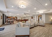 Thumbnail 9 of 30 - A spacious waiting room with a variety of seating options.
