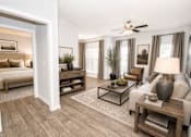Thumbnail 12 of 18 - A living room with a white ceiling fan and a white couch.
