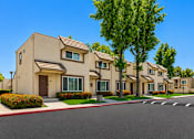 Thumbnail 8 of 12 - A row of modern houses with a tree in front of them.
