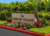 Thumbnail 1 of 12 - A sign that says Sterling Village in front of some plants.