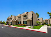 Thumbnail 7 of 12 - A row of houses with a red stripe down the middle of the street.