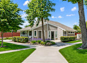 Thumbnail 2 of 5 - A house with a grey roof and a white fence.