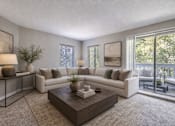 Thumbnail 1 of 9 - A living room with a white couch, a coffee table, and a balcony with chairs.