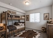 Thumbnail 26 of 33 - Western themed bedroom with rustic bunk beds at Silver Ridge Apartments, Idaho