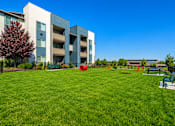 Thumbnail 3 of 33 - Fenced dog park with modern apartment building at Silver Ridge Apartments, Idaho, 83642