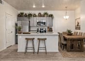 Thumbnail 20 of 33 - Open kitchen with breakfast bar and dining space at Silver Ridge Apartments, Idaho