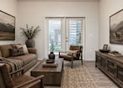 Thumbnail 18 of 33 - Warm living room with earth tones and large windows at Silver Ridge Apartments, Meridian, ID 83642