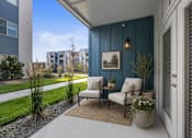Thumbnail 31 of 33 - Covered patio with seating and blue accent wall at Silver Ridge Apartments, Meridian, ID 83642