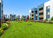 Thumbnail 4 of 33 - Courtyard with playground and landscaped gardens at Silver Ridge Apartments, Meridian, ID