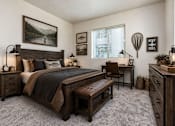 Thumbnail 25 of 33 - Rustic bedroom with fishing themed wall decor at Silver Ridge Apartments, Meridian, 83642