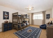 Thumbnail 21 of 21 - Bedroom with wooden bunk bed and football theme at Stonetree Apartments, East Point, 30344