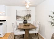Thumbnail 17 of 21 - Dining area with wooden table and upholstered chairs at Stonetree Apartments, East Point