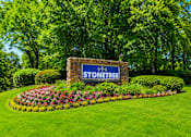 Thumbnail 1 of 21 - Community entrance monument with colorful flower beds at Stonetree Apartments, Georgia, 30344