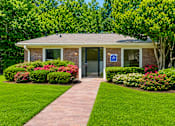 Thumbnail 3 of 21 - Leasing office with brick exterior and manicured lawn at Stonetree Apartments, Georgia