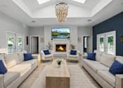 Thumbnail 7 of 15 - A living room with a fireplace and a television mounted above it.
